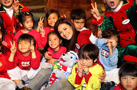 Photo 3: Elanne posing with a group of lovely kids