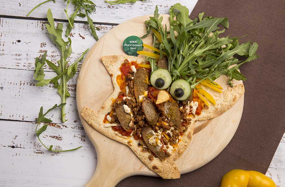 Surprising Pizza - The 100% plant-based beyond sausage is made from beyond meat comprising beetroot the superfood, and dairy-free mozzarella cheese and cheddar cheese.